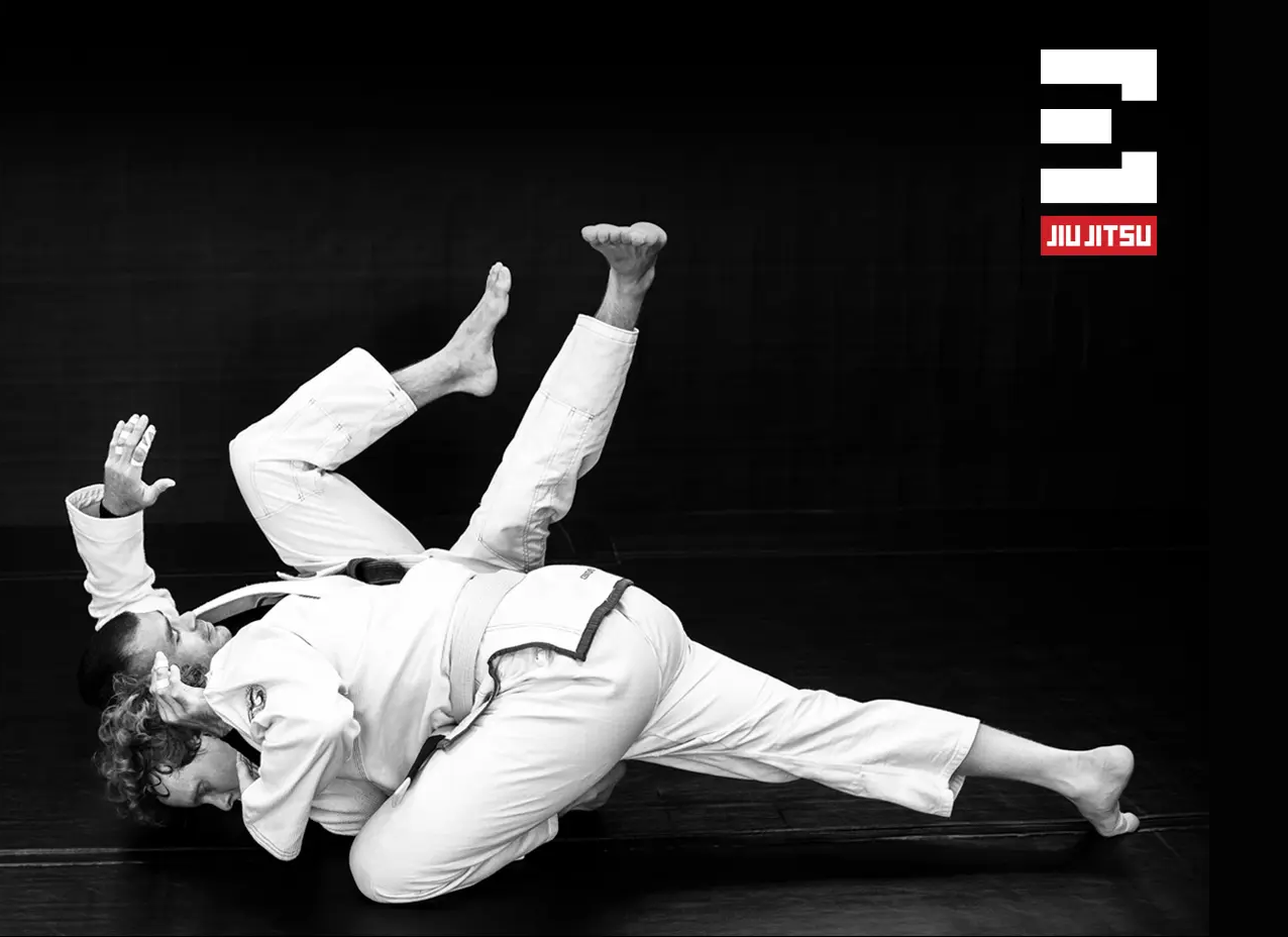 Adult students practicing Brazilian Jiu-Jitsu technique at Elementum