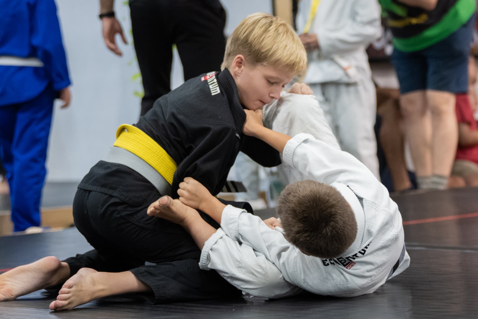 Young student in a gi in the Kids 3 Jiu-Jitsu program at Elementum
